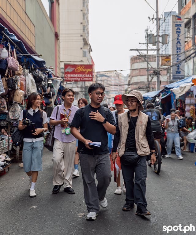 Aldrich Cansino and Stephen Pamorada talk about the next stop as they lead the group through Divisoria to a different part of Tondo